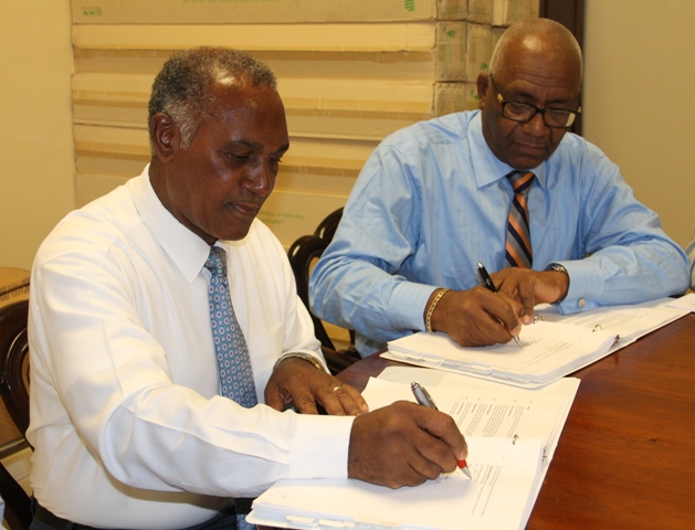 Premier of Nevis Hon. Vance Amory, on behalf of Minister responsible for Public Utilities Hon. Alexis Jeffers, signs an agreement with Wӓrtsilӓ representative, Rodney George, Vice President of Wӓrtsilӓ Caribbean, Inc. for the provision of a new 3.85 megawatt engine at the Nevis Electricity Company Limited’s Board Room on Long Point Road on November 25, 2016